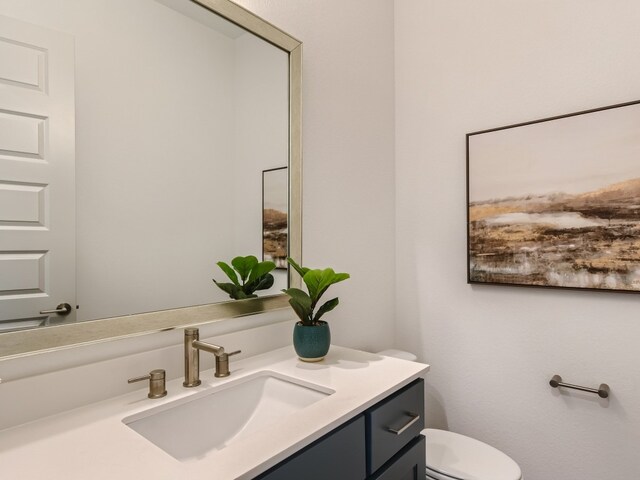 bathroom featuring toilet and vanity