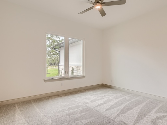 carpeted spare room with ceiling fan and a wealth of natural light