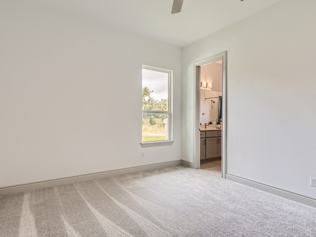 unfurnished room with ceiling fan and light colored carpet