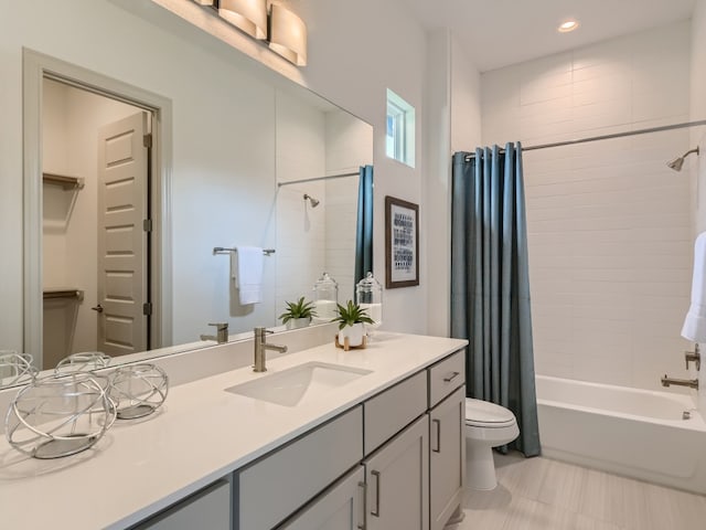 full bathroom featuring shower / tub combo with curtain, vanity, tile patterned floors, and toilet