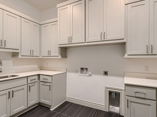 clothes washing area with sink, cabinets, washer hookup, and electric dryer hookup