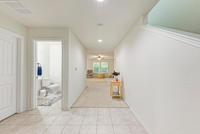 corridor featuring light tile patterned floors