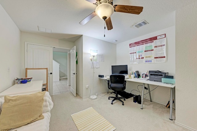 home office with ceiling fan, light colored carpet, and a textured ceiling