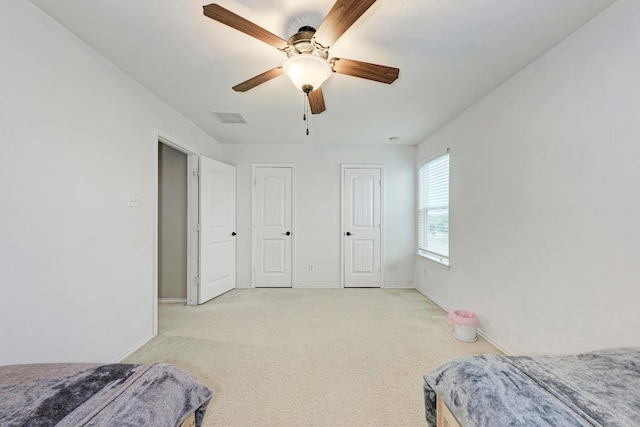 bedroom with ceiling fan and light colored carpet