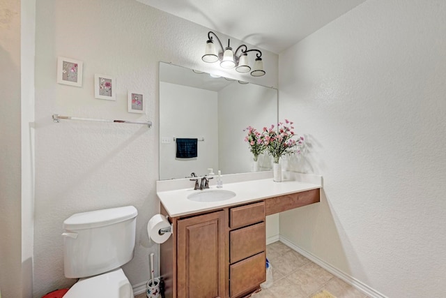 bathroom featuring tile patterned flooring, toilet, and vanity