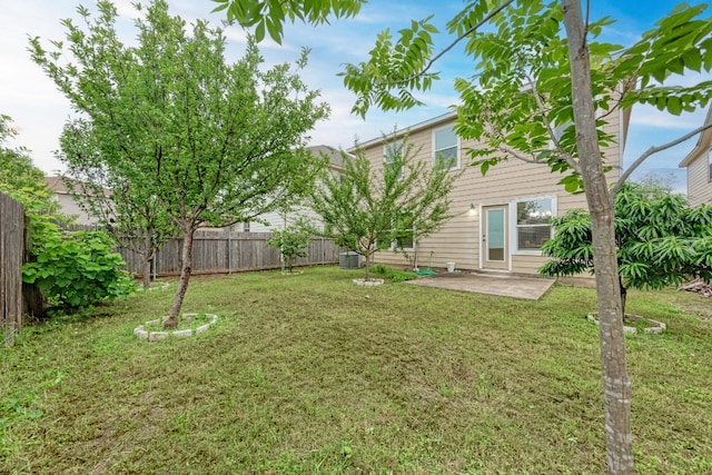 view of yard featuring central AC unit and a patio