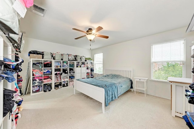 bedroom with light carpet and ceiling fan