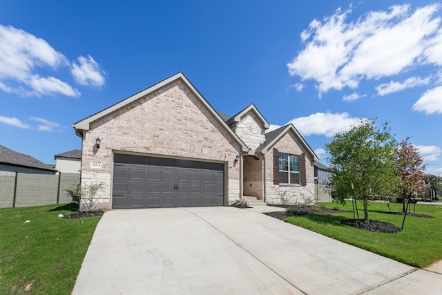 view of front of property with a front yard and a garage