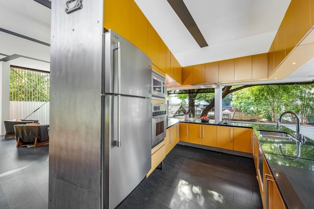 704 W Live Oak St, Austin, TX 78704 - kitchen featuring stainless steel appliances, a sink, and dark countertops