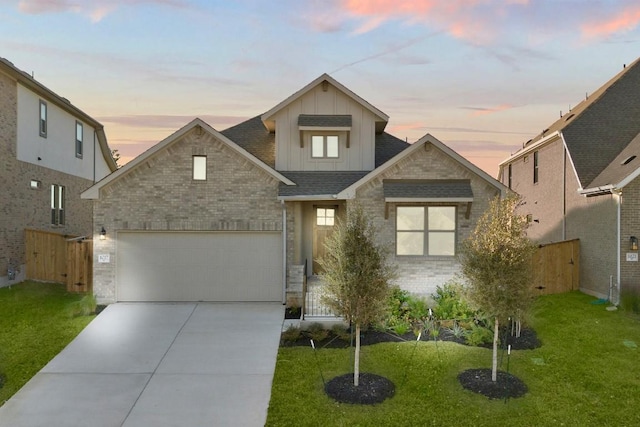 view of front of house featuring a yard and a garage