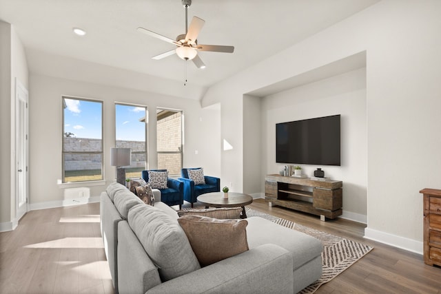 living room featuring ceiling fan and hardwood / wood-style floors