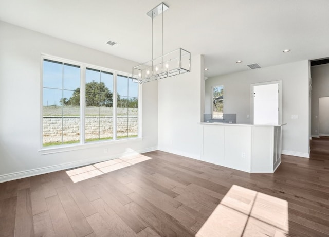 unfurnished dining area with dark hardwood / wood-style floors