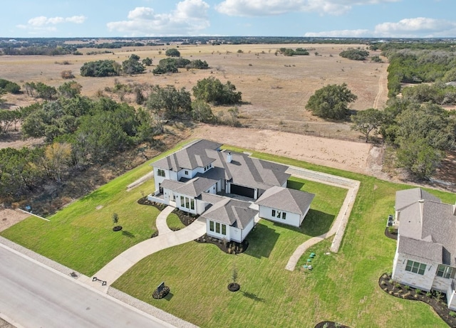 birds eye view of property with a rural view