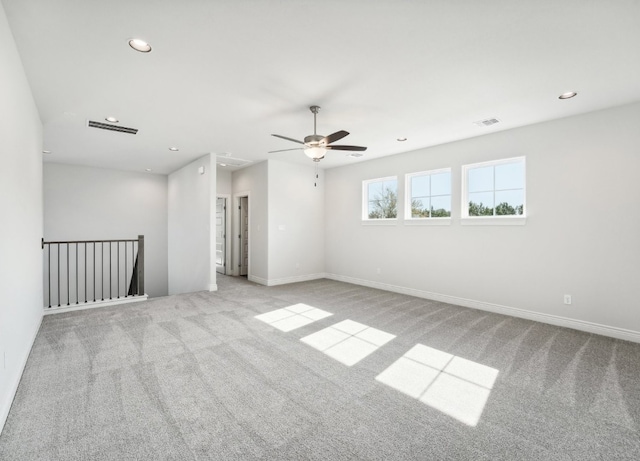 carpeted spare room with ceiling fan