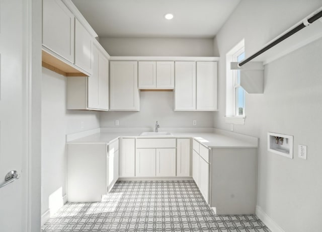 kitchen with white cabinetry and sink