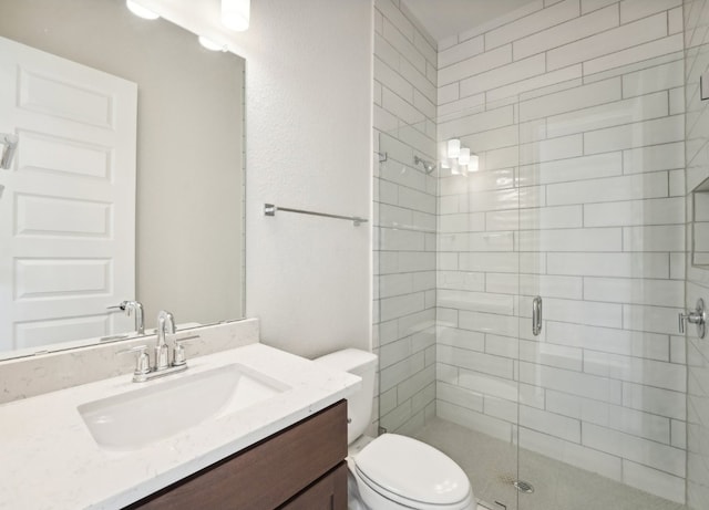 bathroom with vanity, toilet, and a shower with shower door