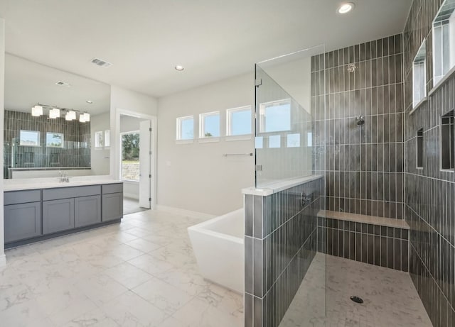 bathroom featuring vanity and shower with separate bathtub