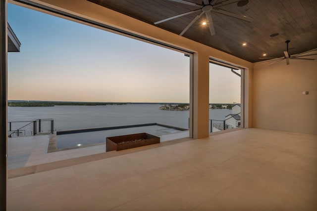 interior space featuring ceiling fan and a water view