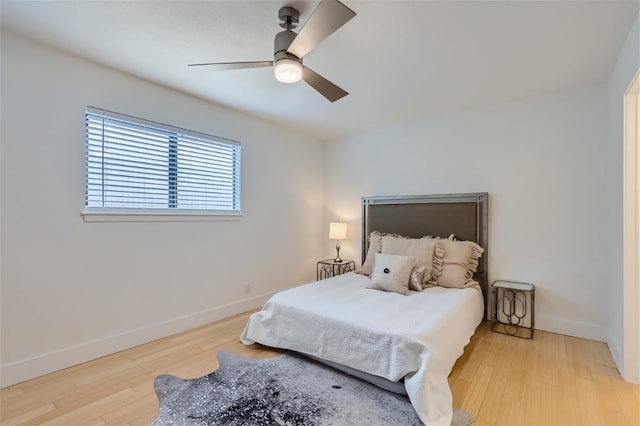 bedroom with ceiling fan and light hardwood / wood-style flooring