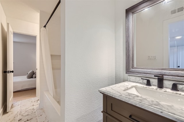 bathroom featuring vanity and shower / bath combo