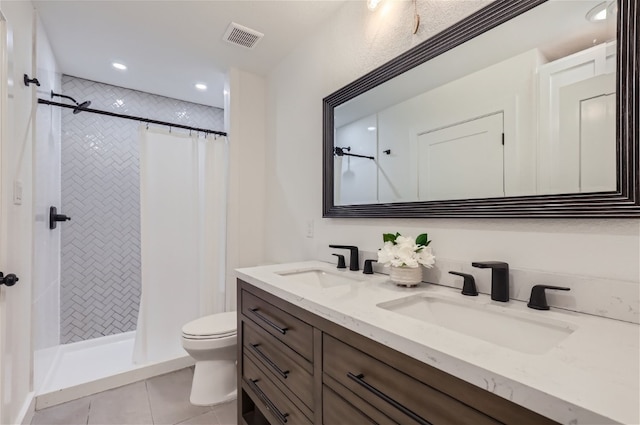 bathroom featuring tile patterned flooring, vanity, curtained shower, and toilet