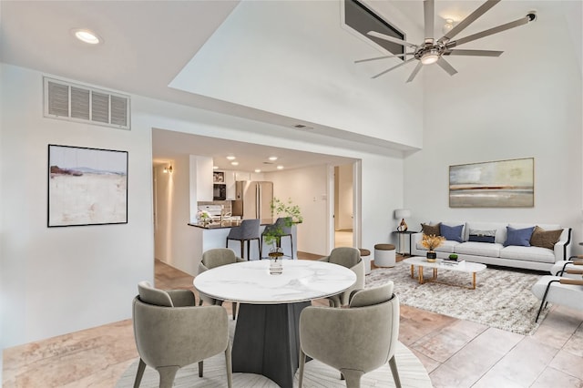 dining space with ceiling fan and light tile patterned flooring