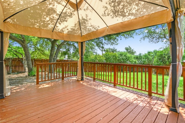 wooden deck featuring a gazebo and a yard