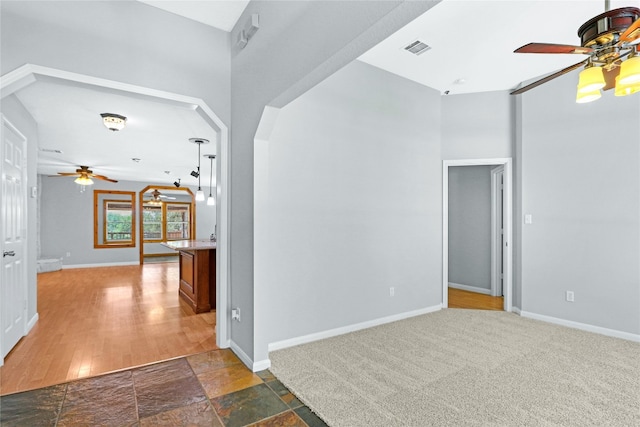 tiled spare room with ceiling fan