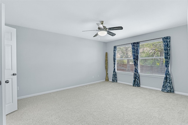 carpeted spare room with ceiling fan