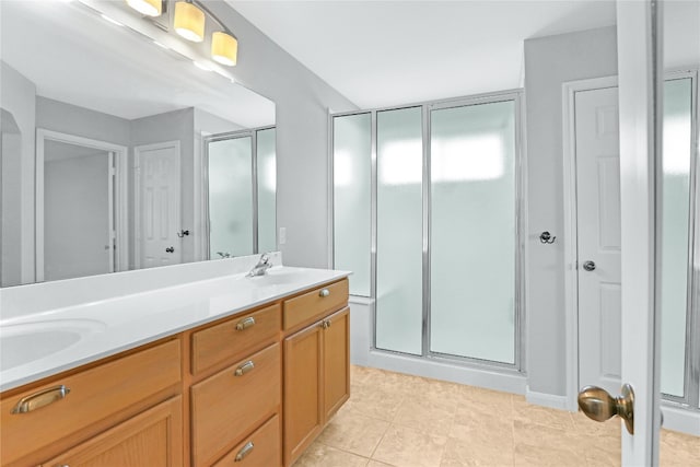 bathroom featuring tile floors, an enclosed shower, and double vanity