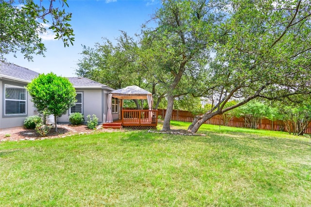 view of yard with a deck and a gazebo