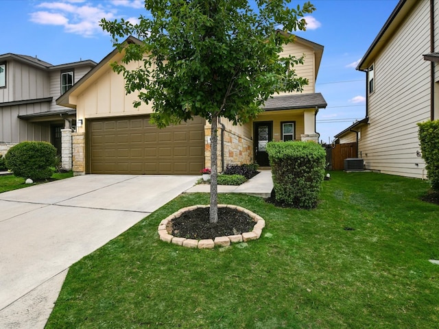 view of front of property featuring a front yard, a garage, and central AC