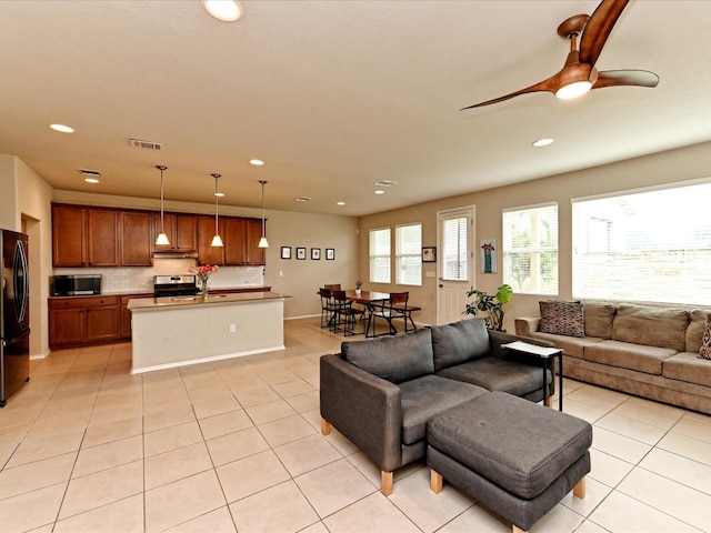 tiled living room featuring ceiling fan