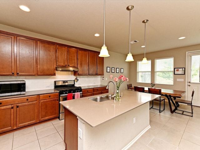 kitchen with backsplash, sink, light tile flooring, and appliances with stainless steel finishes