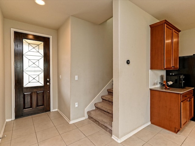 entrance foyer featuring light tile floors