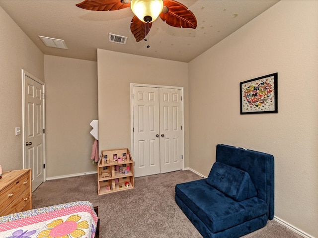 carpeted bedroom with a closet and ceiling fan