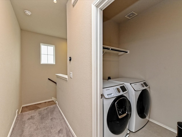 laundry area with washer and dryer and carpet