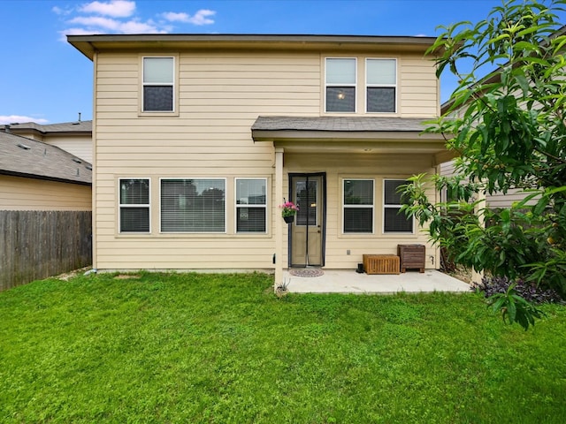 rear view of house featuring a yard