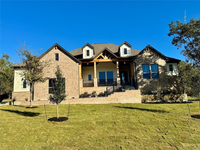 view of front of house featuring covered porch and a front yard