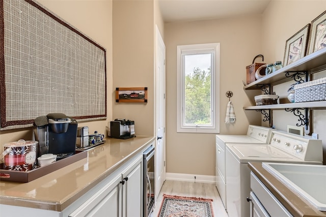 washroom with washer and clothes dryer, sink, beverage cooler, and hookup for a washing machine