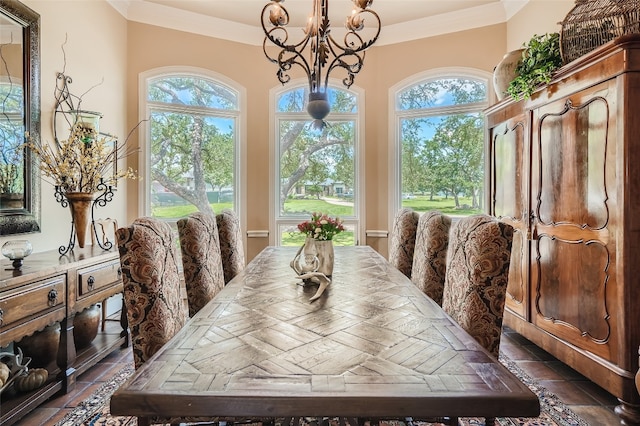 tiled dining area with a healthy amount of sunlight, ornamental molding, and a chandelier