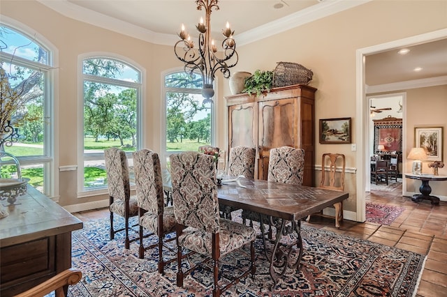 tiled dining area featuring a chandelier, ornamental molding, and plenty of natural light