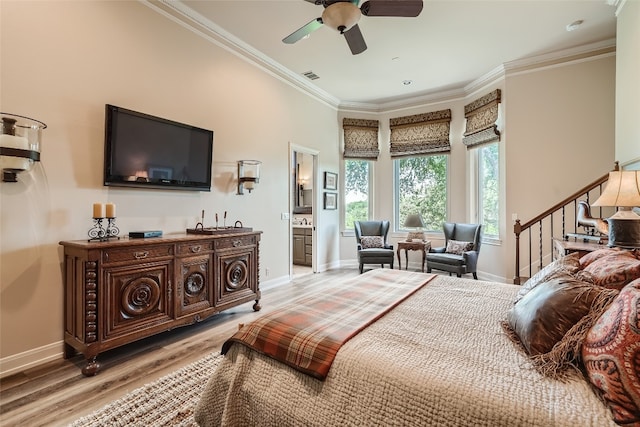 bedroom with wood-type flooring, ensuite bath, ceiling fan, and crown molding