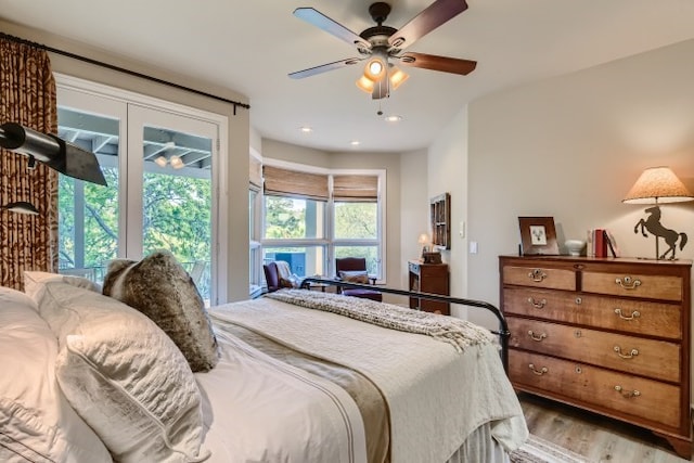 bedroom with ceiling fan, light hardwood / wood-style floors, and access to exterior