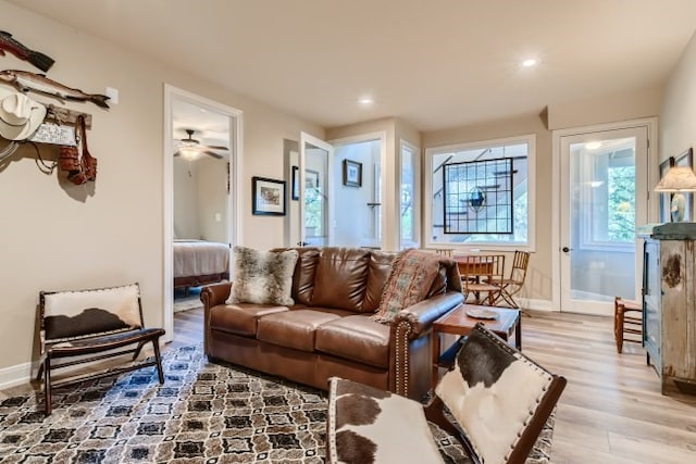 living room with ceiling fan and light hardwood / wood-style floors