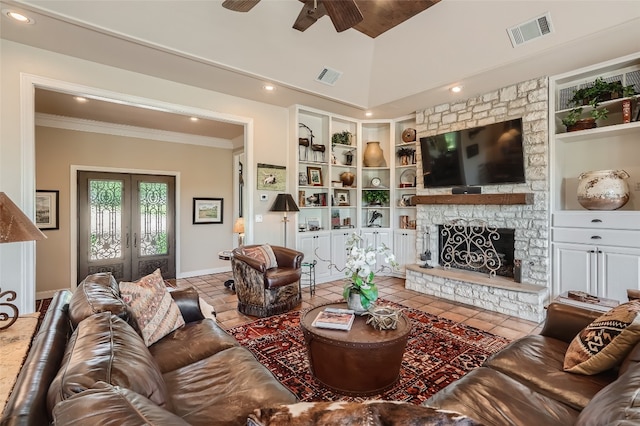 tiled living room featuring french doors, built in shelves, ceiling fan, and a fireplace