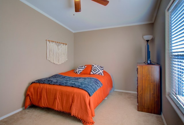 carpeted bedroom featuring ornamental molding and ceiling fan