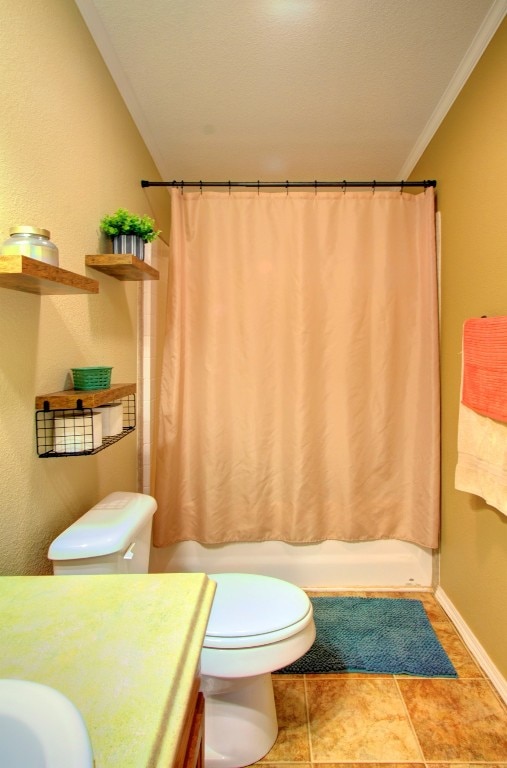 full bathroom with ornamental molding, shower / tub combo, vanity, and toilet