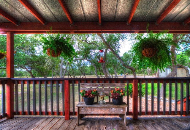 wooden terrace with a storage unit and a yard