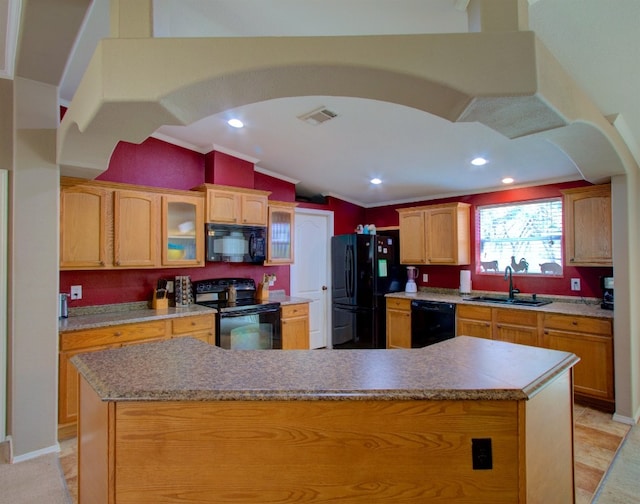 kitchen featuring a kitchen island, black appliances, vaulted ceiling, and sink